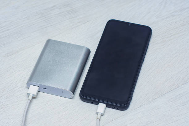 istock The smartphone is being charged using a portable charger on a wooden table. 1559805621