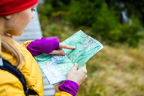 istock Woman hiking and reading map in forest 155980770