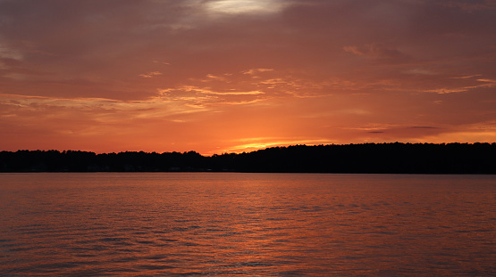 The sky is fiery right after the sun sets on beautiful Lake Sinclair in Milledgeville, Georgia.