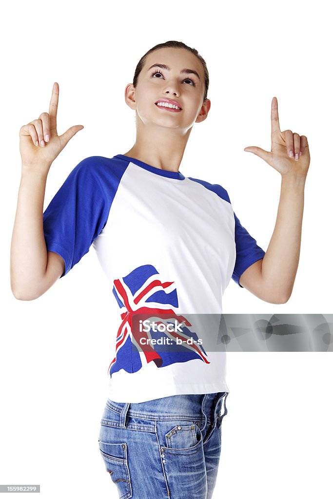 Garota adolescente apontando para cima no espaço para texto. - Foto de stock de Bandeira da Grã-Bretanha royalty-free