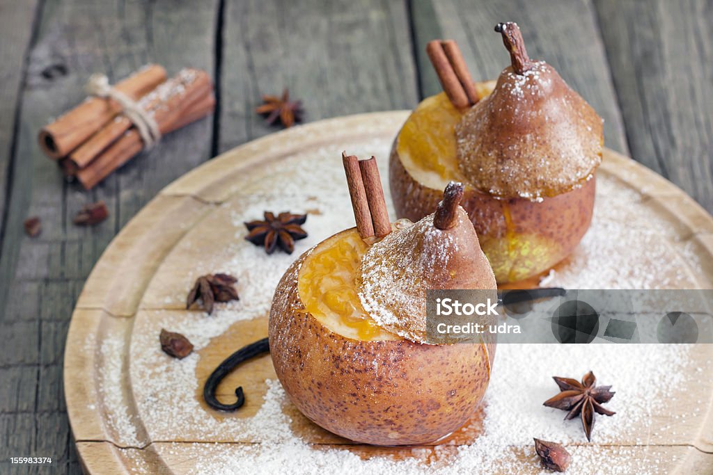 Christmas food baked pears with jam Christmas food baked pears with jam ,cinnamon and anise on wooden boards Christmas Stock Photo
