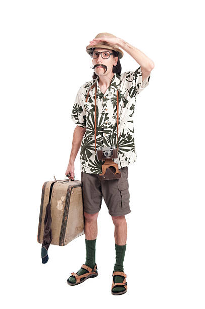A tourist with luggage in hand looking lost and confused stock photo