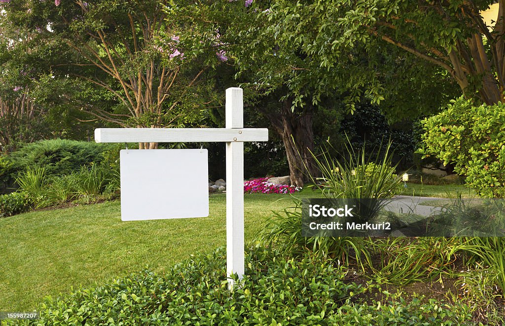 For Sale Sign In Yard Blank white For Sale sign in well manicured yard Sign Stock Photo