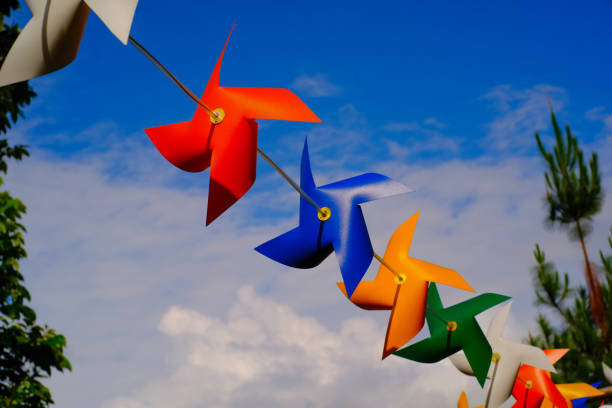 istock Colorful Pinwheel Toy Landscape Under a Blue Sky 1559905502