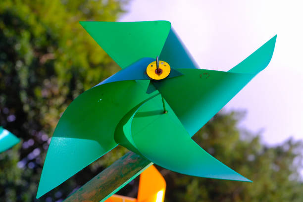 istock Green Pinwheel Toy on Artificial Park 1559911017
