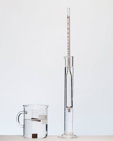 An equipment to measure the density and specific gravity of solids and liquids on a white background