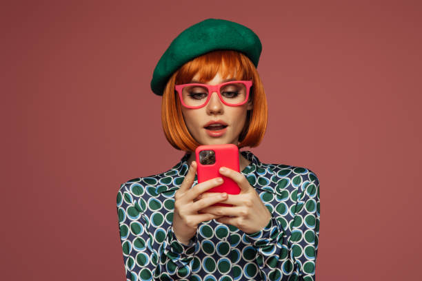istock Beautiful emotional woman using phone 1559926076