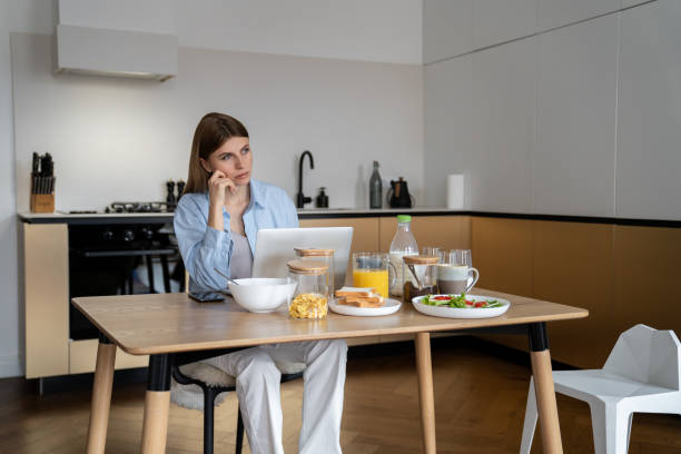 istock Female freelancer making business call while working remotely from home 1559979176