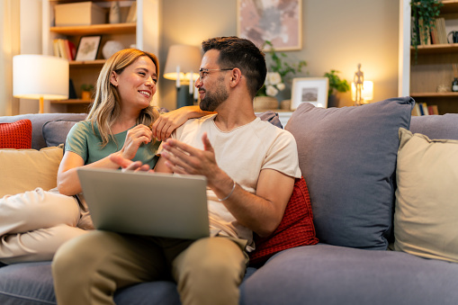 Couple paying bills online, calculate expenses at home