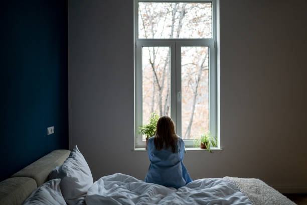 istock Alone woman sit on bed at home pondering solution trouble, suffer from breakup, divorce, feel unwell 1559986675
