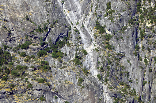 Small green trees grow on the slopes of the mountains