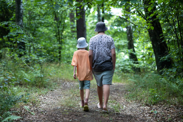 istock Young Boys walking in the forest 1560008591