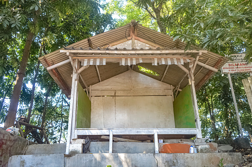 a wooden security post in a village in the city of Gresik, East Java, Indonesia