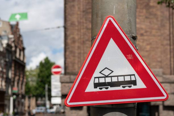 A street sign in Amsterdam, Netherlands advises pedestrians cyclists and driver to beware of trams.