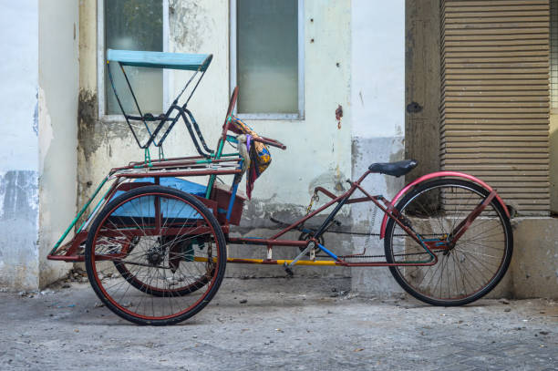 istock a rickshaw parked on the side of the road. 1560028844
