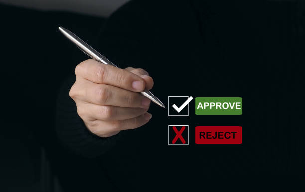 istock Businessman writing or tick correct mark to approve document and project concept. 1560029512