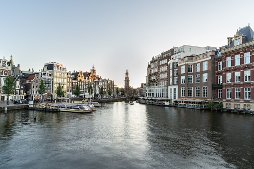 Amsterdam, Netherlands – August 15, 2020: Panoramic view of Amsterdam city centre, showing the Amstel River and Munttoren tower in the background.