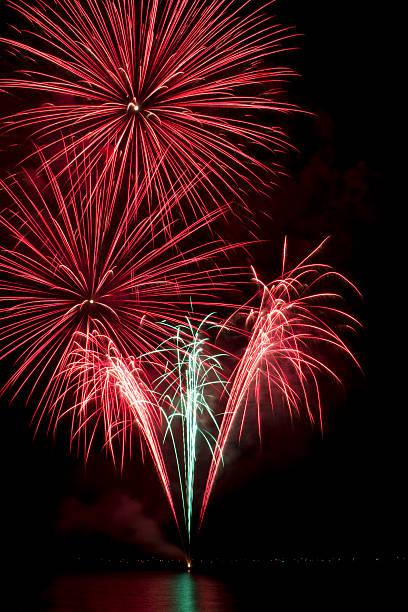 istock Red and green fireworks on a lake 156003248