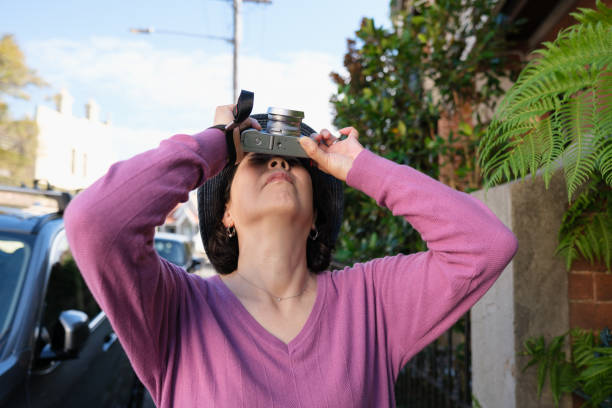istock Woman outdoors taking a photo with her camera 1560037853