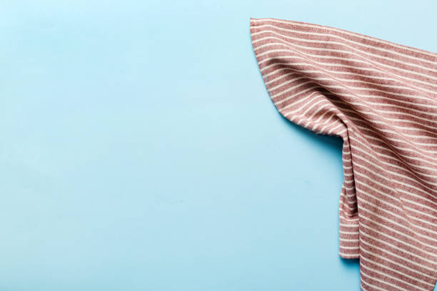 istock top view with red empty kitchen napkin isolated on table background. Folded cloth for mockup with copy space, Flat lay. Minimal style 1560042772
