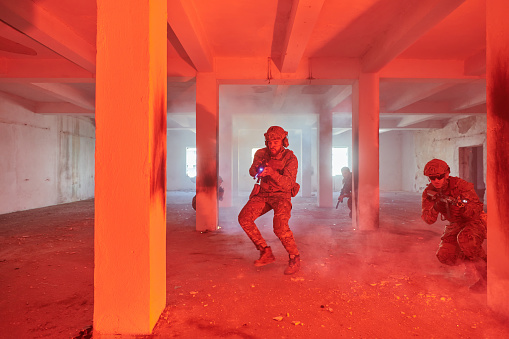 group of professional soldiers destroyed the wall and attack a building.