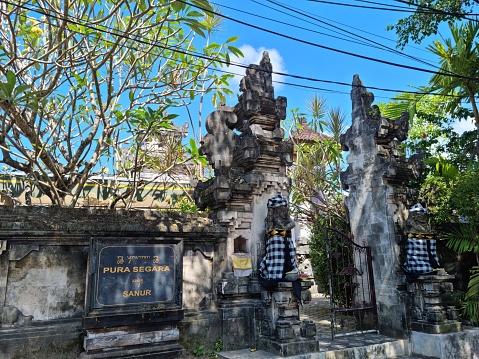 Sanur, Bali - July 16, 2023: Front picture of open public Hinduism temple for people to pray and give offering in Sanur beach