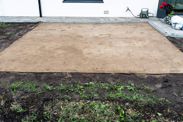 istock Rolling yellow sand with a steel roller for a garden pool, empty square visible. 1560062763