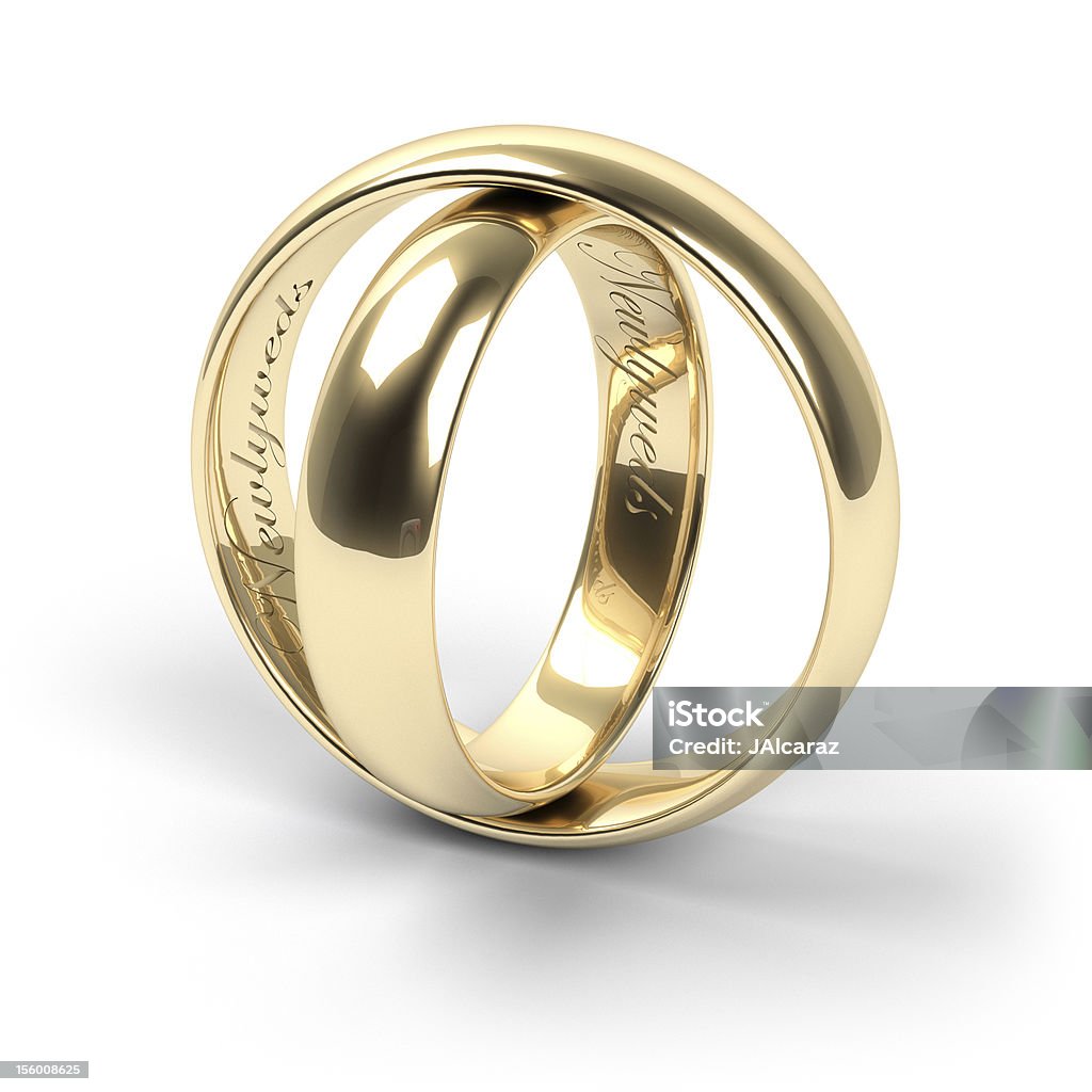 Wedding rings Gold wedding rings engraved with the text Newlyweds Engraved Image Stock Photo