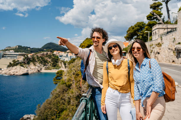 istock Three Young Friends Looking At View From A High Viewpoint In Dubrovnik 1560123319