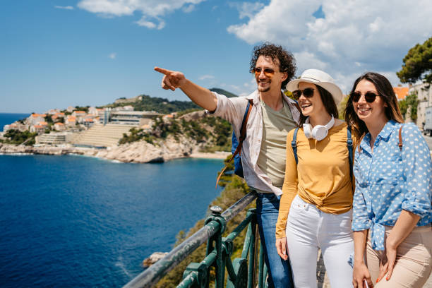 istock Three Young Friends Looking At View From A High Viewpoint In Dubrovnik 1560126065