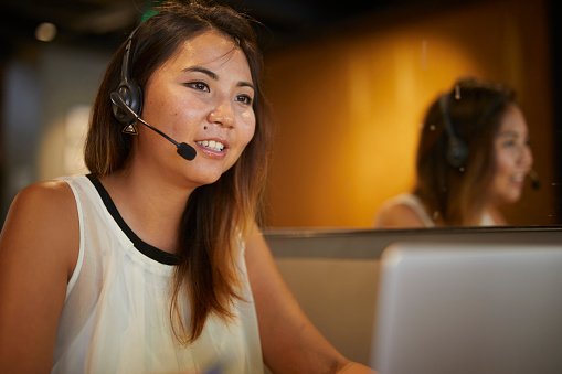 istock Young lady helpdesk worker communicating with customer 1560128186