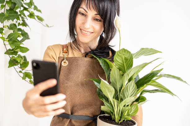 istock Female gardener make take selfie 1560140786