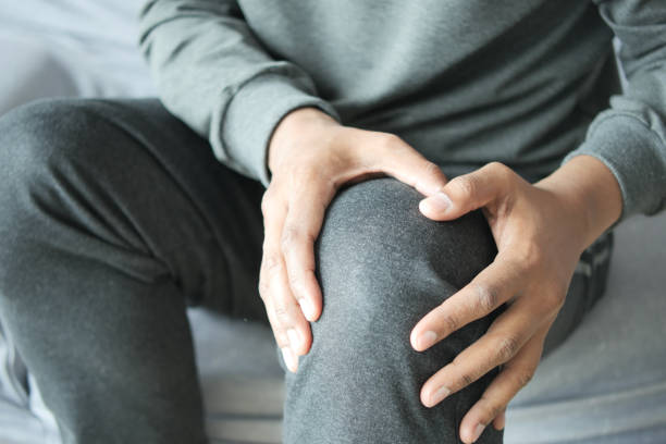 istock Close up on man suffering knee joint pain 1560142920