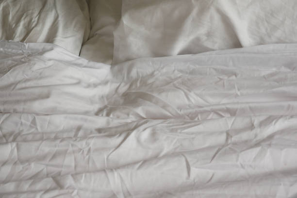 istock messy bed in early morning , messy bed after waking up 1560147715