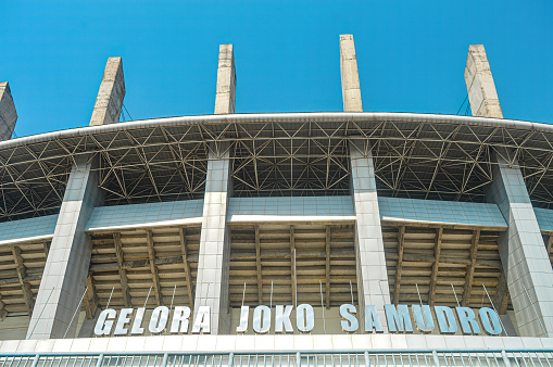 the front view of the Gelora Joko Samudro Stadium with a bright blue sky during hot weather, Indonesia, 17 July 2023.