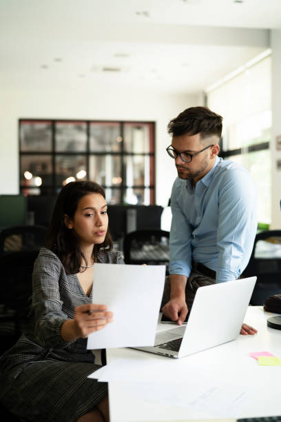 istock Colleagues working together in office. 1560175066