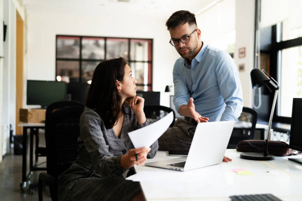 istock Colleagues working together in office. 1560175619