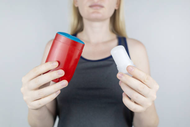 istock left or right. Girl chooses between eco-friendly deodorant without toxins and antiperspirant with toxic elements. In left hand Mineral alum crystal stick, in right hand classic remedy chemical nature 1560177877