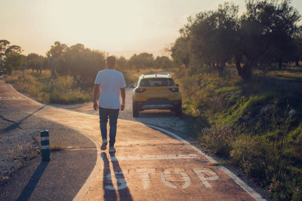 Latino man walking to his car at sunset