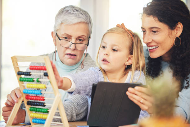 Grandma, mother and girl on tablet for education in home for lesson, homework and learning online. Grandparent, family and mom and kid on digital tech for educational games, remote school and study abuela, madre y niña en tableta para la educación en el hogar para la lección, la tarea y el aprendizaje de matemáticas en línea. abuelo, familia y mamá e hijo en tecnología digital para juegos educativos, educación en el hogar y estudio