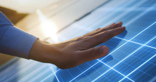 istock Close Up on Hand Of Professional Maintenance Engineer Touching Industrial Solar Panel Generating Electricity. VFX Graphics Edit Visualizing Energy Being Generated. Sustainable Energy Concept. 1560202735