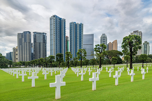 Manila, Philippines - February 3, 2018: The American Battle Monuments Commission. Manila American Cemetery and Memorial. Landscape. Skyscraper in Background. Philippines
