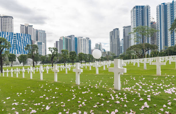 The American Battle Monuments Commission. Manila American Cemetery and Memorial. Landscape. White Air Balloon on the white cross. Philippines Manila, Philippines - February 3, 2018: The American Battle Monuments Commission. Manila American Cemetery and Memorial. Landscape. White Air Balloon on the white cross. Philippines taguig stock pictures, royalty-free photos & images