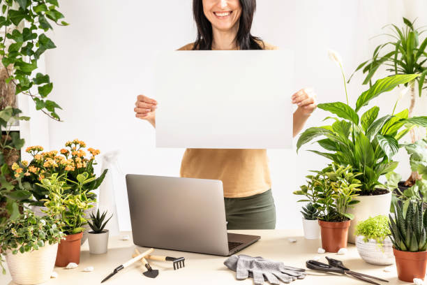 istock woman gardener holding blank billboard 1560209926