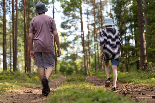 istock Young Boys walking in the forest 1560214676