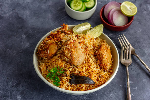 istock Indian Chicken Biryani with Condiments on Darker Background 1560224743