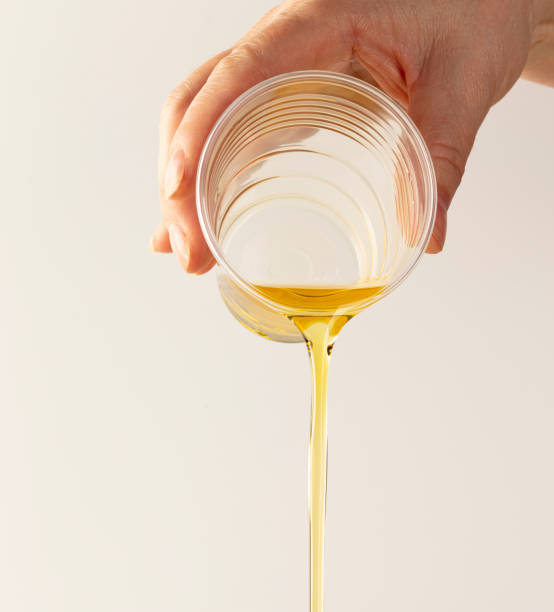 istock Pour fresh olive oil with a glass 1560226177