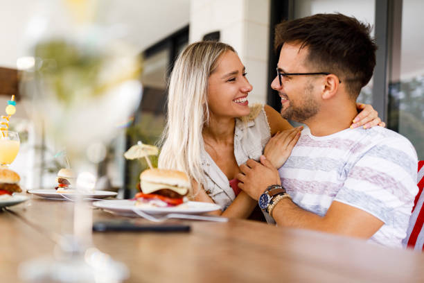 istock Happy couple in love talking during meal at dining table. 1560241913