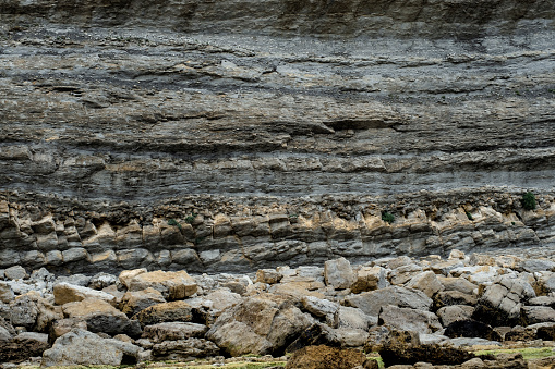 Rhythmic stratification of sedimentary rocks deposited in horizontal layers. Broken Coast of Liencres, Cantabria, Spain.