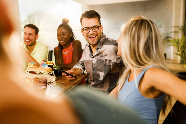 istock Cheerful couple talking during social gathering on a patio. 1560250453